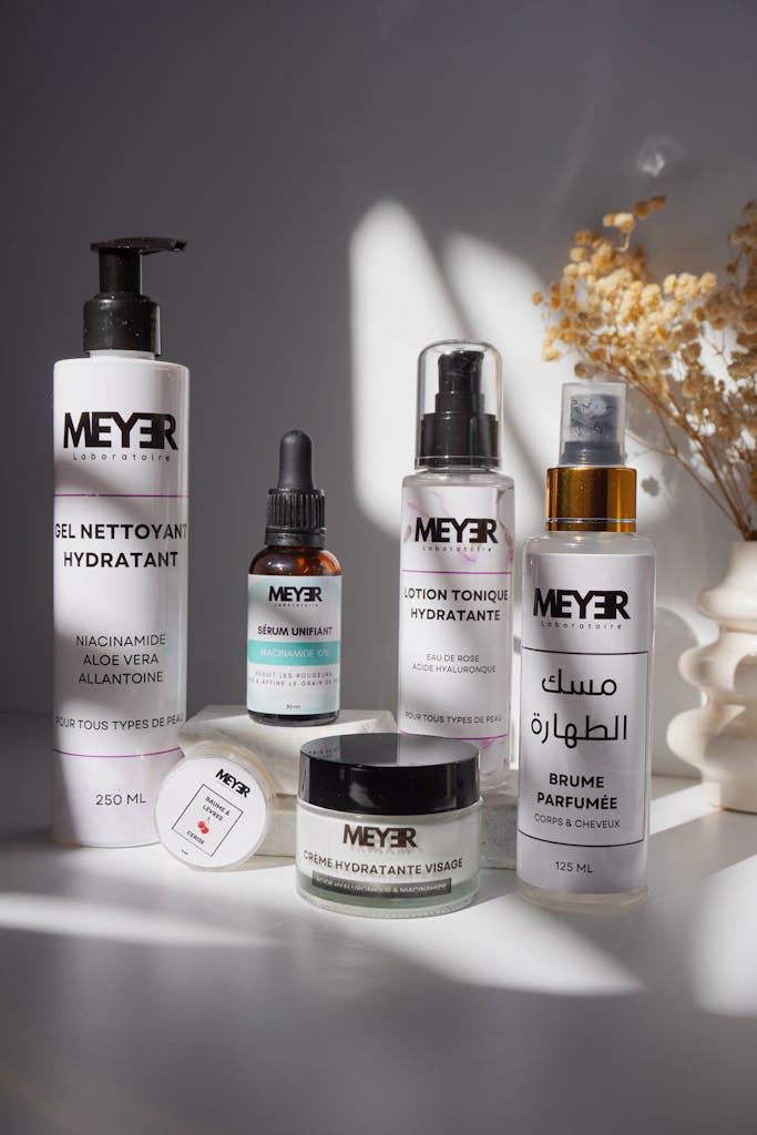 Elegant Meyer skincare product set with dried flowers in natural lighting